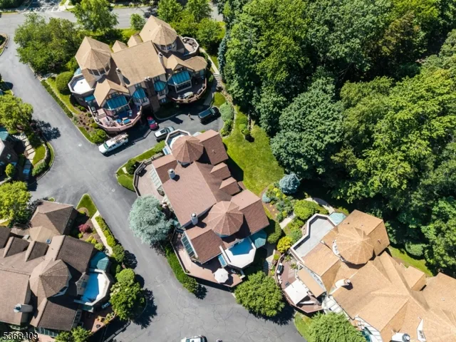 an aerial view of multiple houses with yard