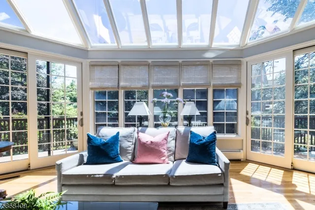 a living room with furniture and floor to ceiling windows