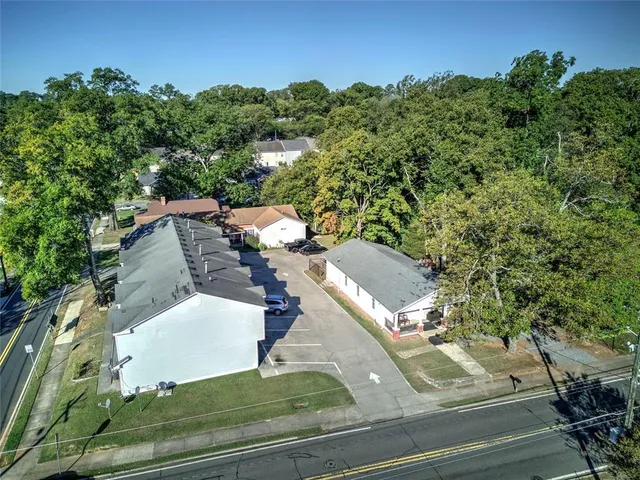an aerial view of a residential houses with yard