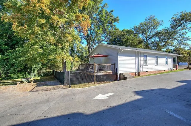 a view of a house with a yard and a garage