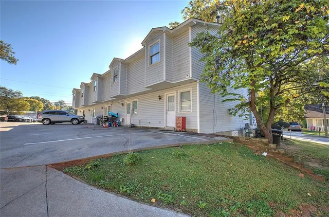 a view of a house with swimming pool and sitting area