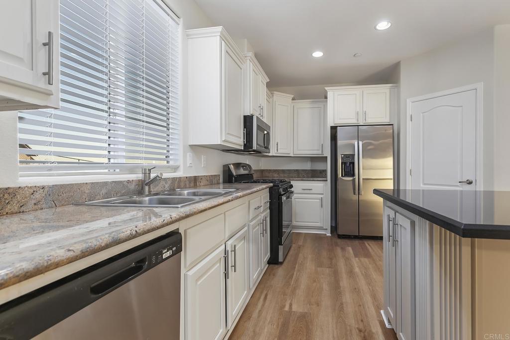 365 Alpine Heights Road Alpine, CA 91901 - Photo 15 of 52 a kitchen with a sink a refrigerator a window and wooden floor