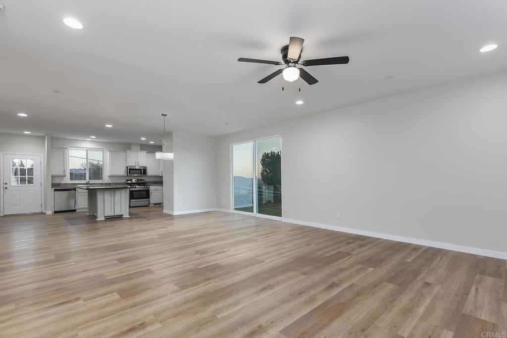 365 Alpine Heights Road Alpine, CA 91901 - Photo 4 of 52 a view of an empty room with kitchen view and a window