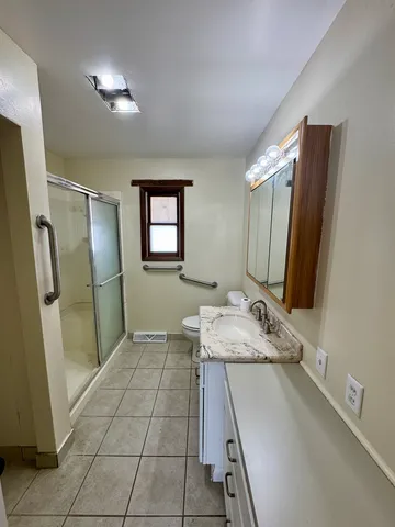 a bathroom with a sink a mirror and a shower