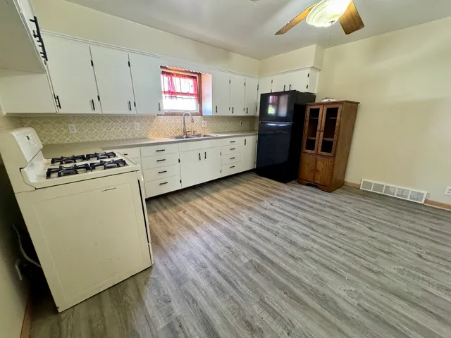 a kitchen with stainless steel appliances granite countertop a refrigerator and a stove