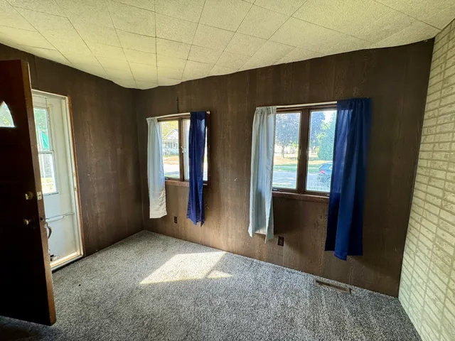 a view of entryway with wooden floor and windows