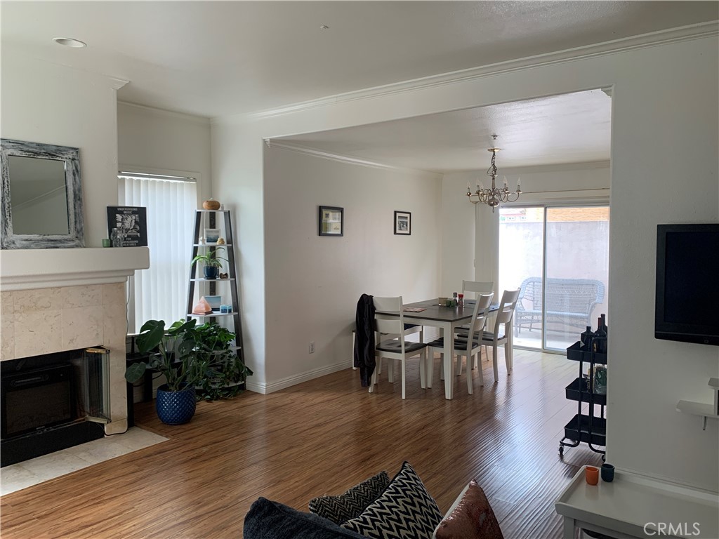 110 North Marengo Avenue, Unit D Alhambra, CA 91801 - Photo 3 of 14 a dining room with furniture a fireplace and wooden floor