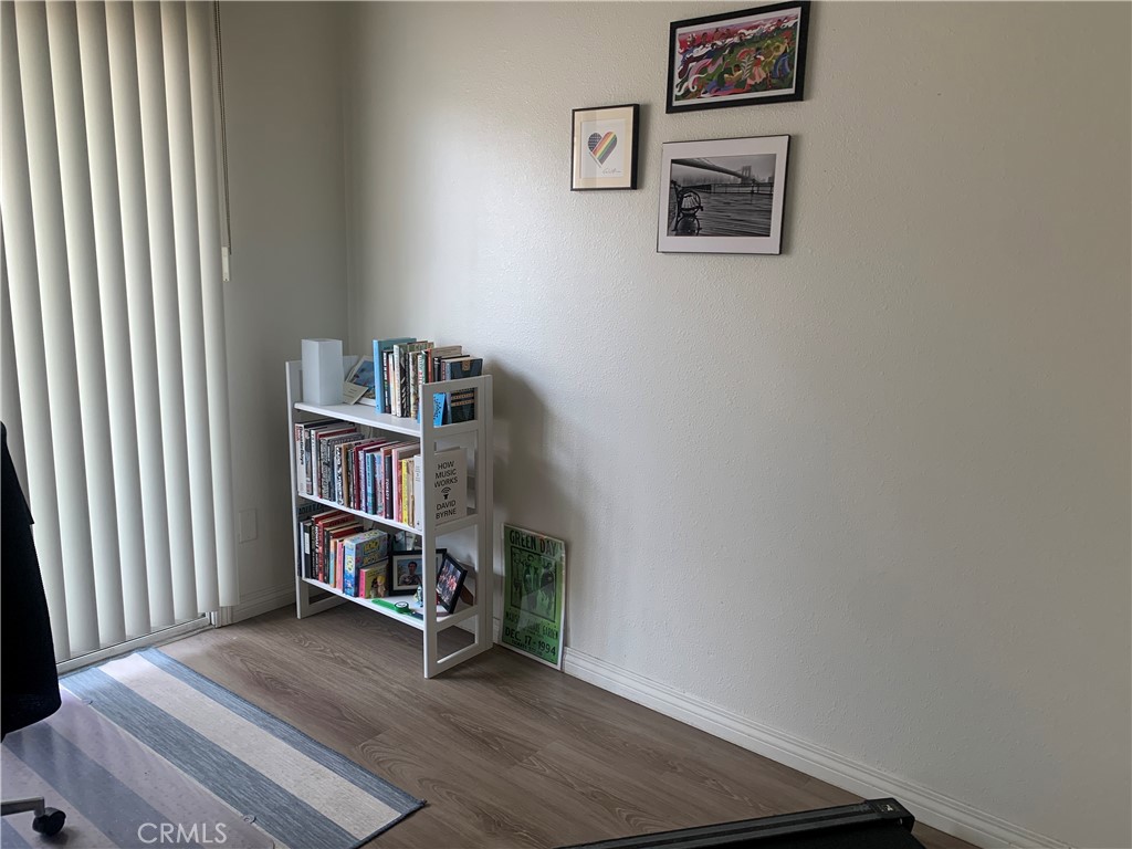 110 North Marengo Avenue, Unit D Alhambra, CA 91801 - Photo 7 of 14 a room with bookshelf and wooden floor