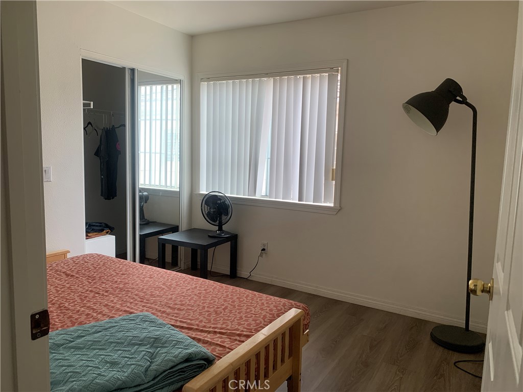 110 North Marengo Avenue, Unit D Alhambra, CA 91801 - Photo 8 of 14 a bedroom with a bed and wooden floor
