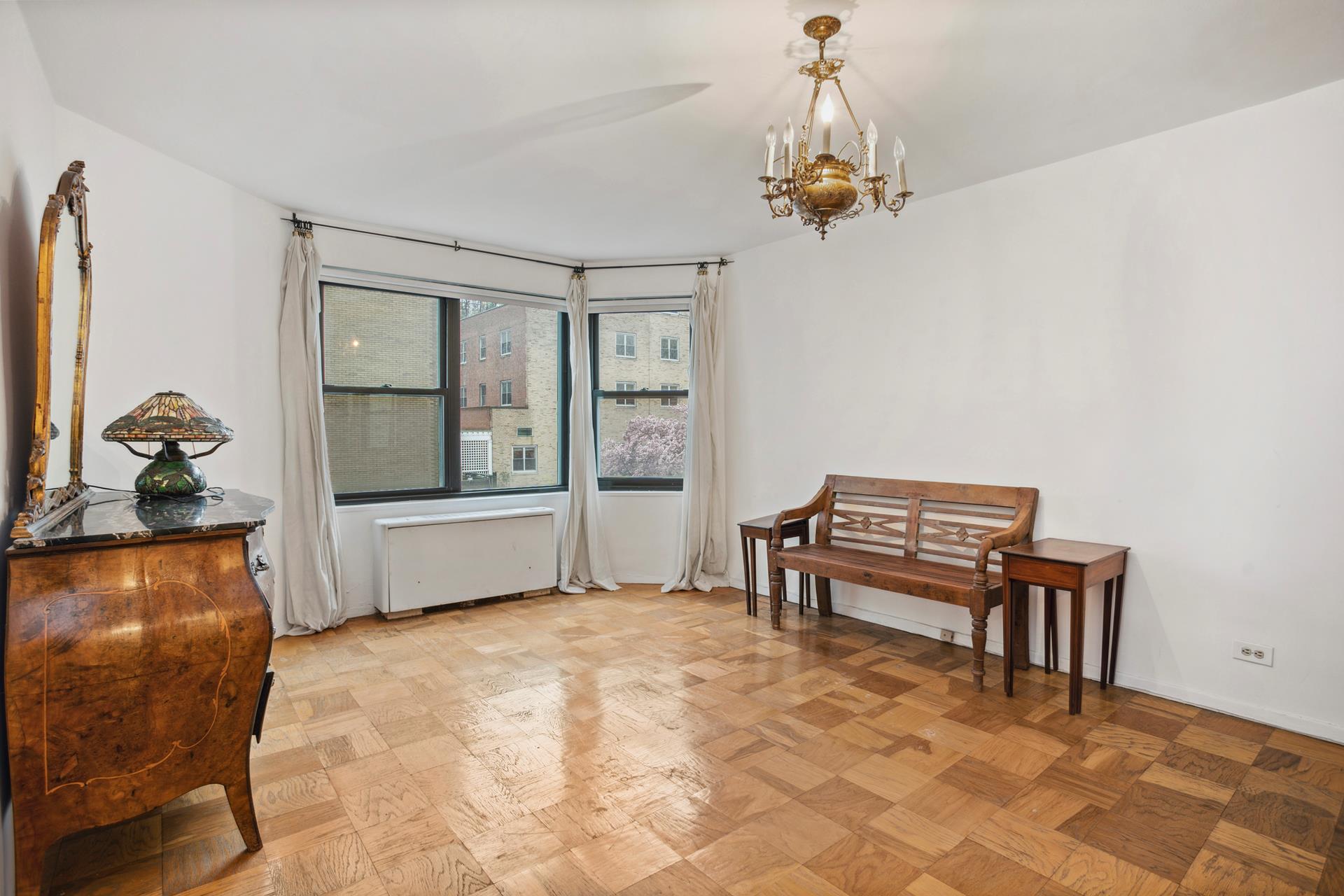 40 East 84th Street, Unit 4A Manhattan, NY 10028 - Photo 11 of 22 a living room with furniture and a window