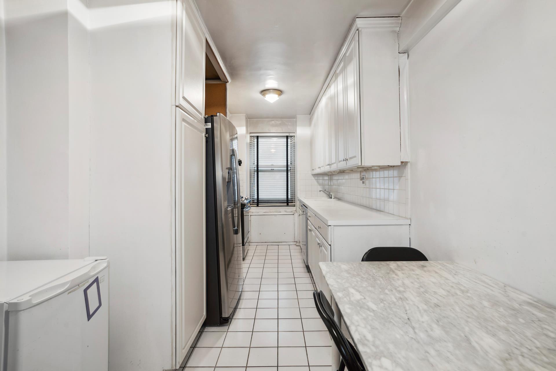 40 East 84th Street, Unit 4A Manhattan, NY 10028 - Photo 6 of 22 a view of a hallway with washer and dryer