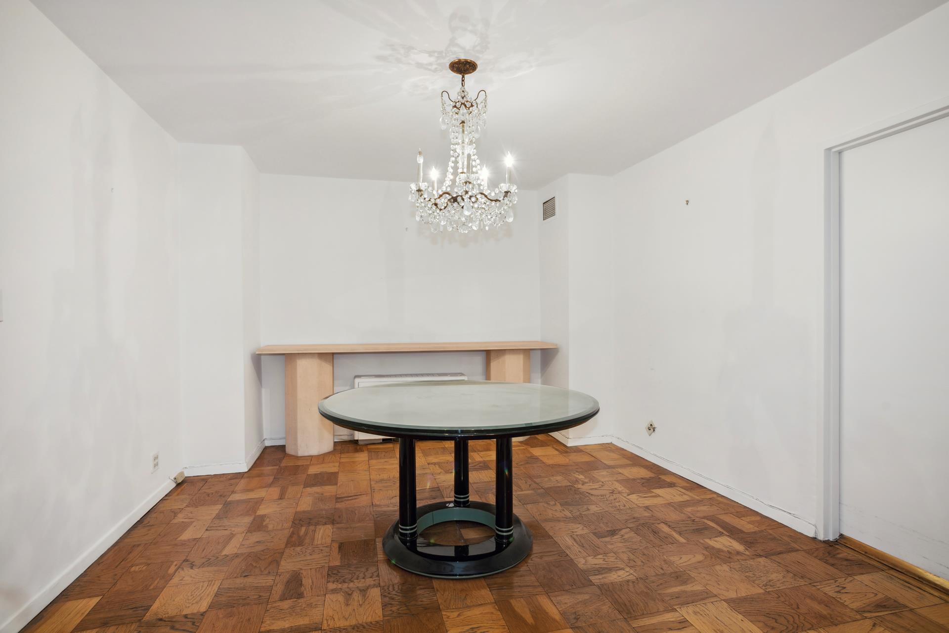 40 East 84th Street, Unit 4A Manhattan, NY 10028 - Photo 9 of 22 a view of a room with a chandelier fan and wooden floor