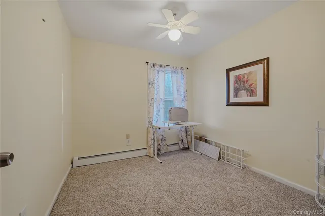 a view of room with lounge chair and a ceiling fan