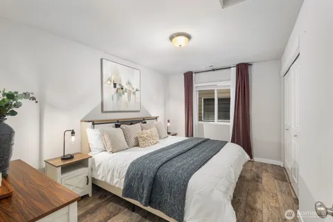 a bedroom with a large bed and a window