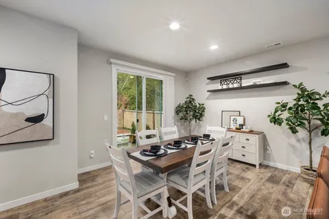 a view of a dining room with furniture window and wooden floor
