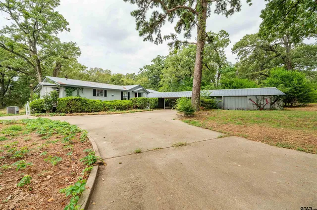 a view of house with yard and green space