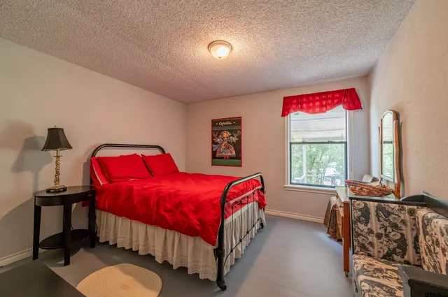 a bedroom with a bed and a window