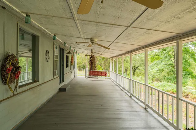 a view of hallway with wooden floor