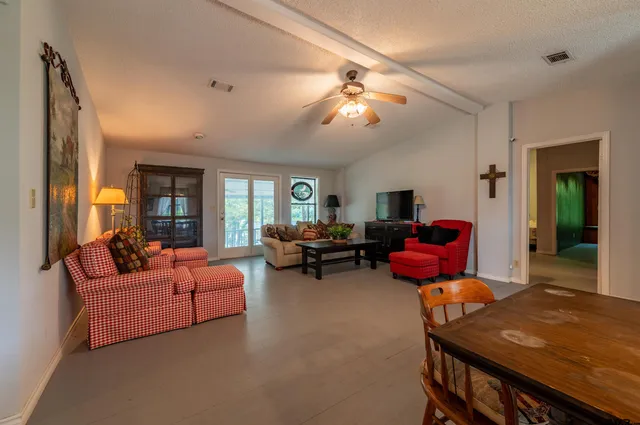 a living room with furniture and a chandelier