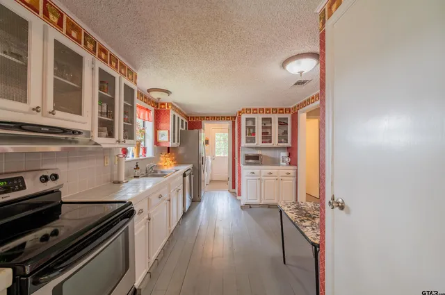 a kitchen with stainless steel appliances granite countertop a stove and a refrigerator