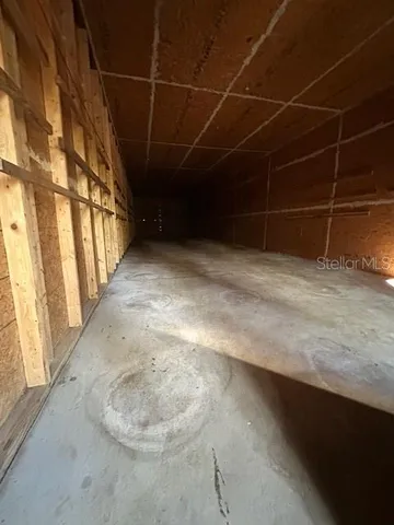a view of a room with a wooden roof and window