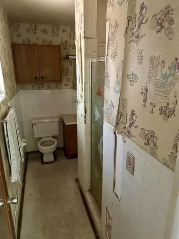 a bathroom with a toilet sink and mirror