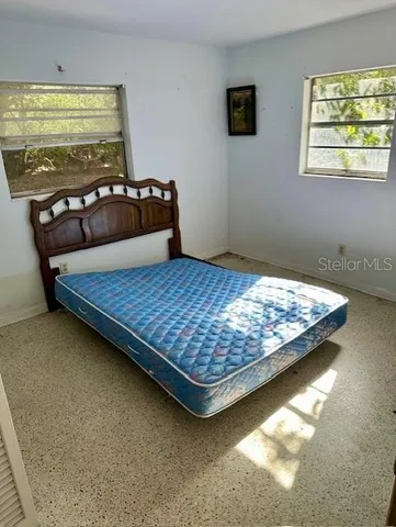 a bedroom with a bed and a couch