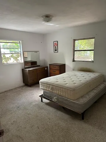 an empty room with a fireplace and window