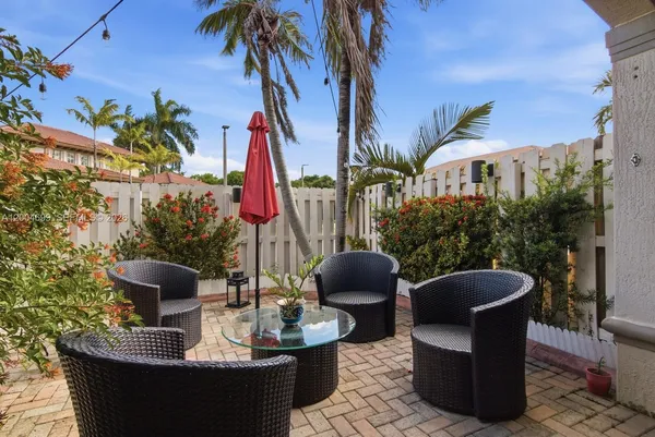 a view of a patio with couches and potted plants