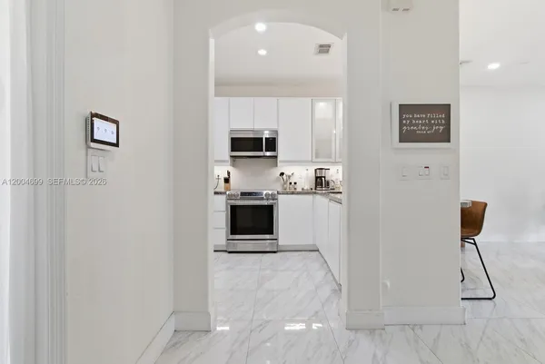 a kitchen with stainless steel appliances a refrigerator and a stove top oven