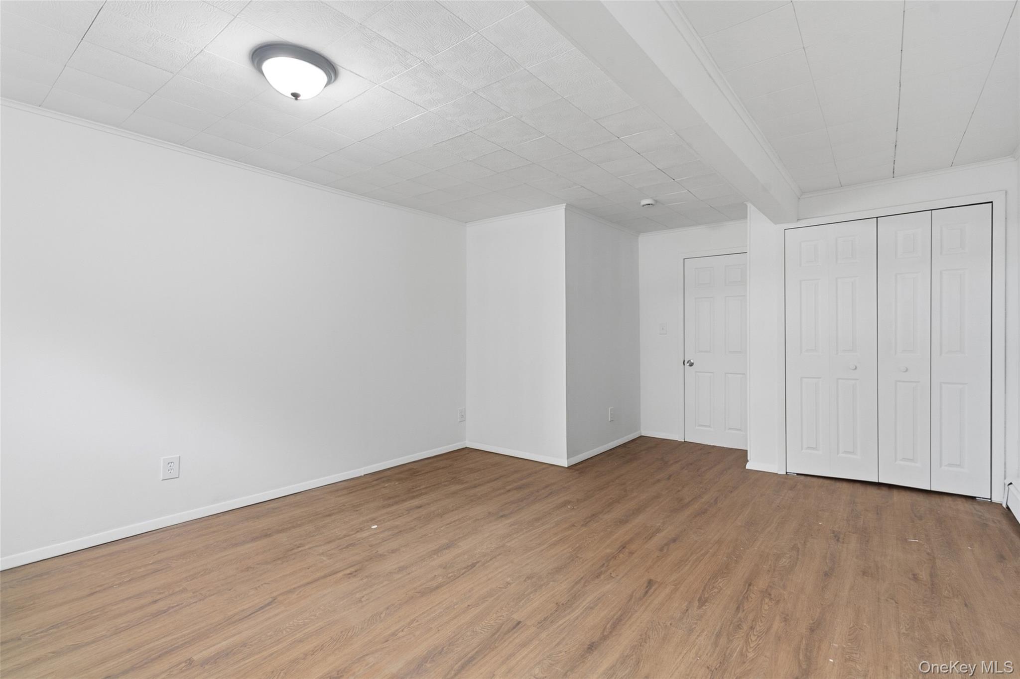 32 North Clover Street Poughkeepsie, NY 12601 - Photo 10 of 20 Unfurnished bedroom featuring light wood-style floors and a closet