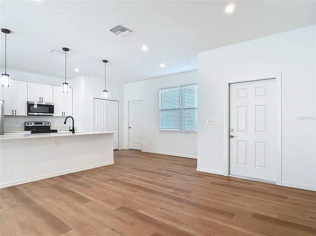 a view of kitchen with wooden floor and window