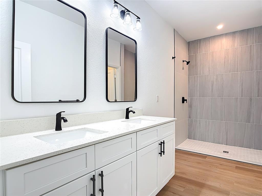 1204 Goshen Road North Port, FL 34288 - Photo 21 of 46 a bathroom with 2 sink and a mirror