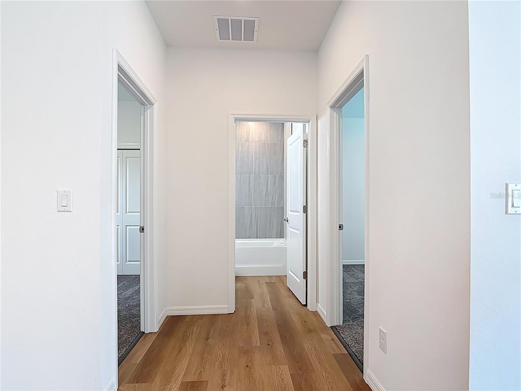 1204 Goshen Road North Port, FL 34288 - Photo 25 of 46 a view of a room with wooden floor and a bathroom