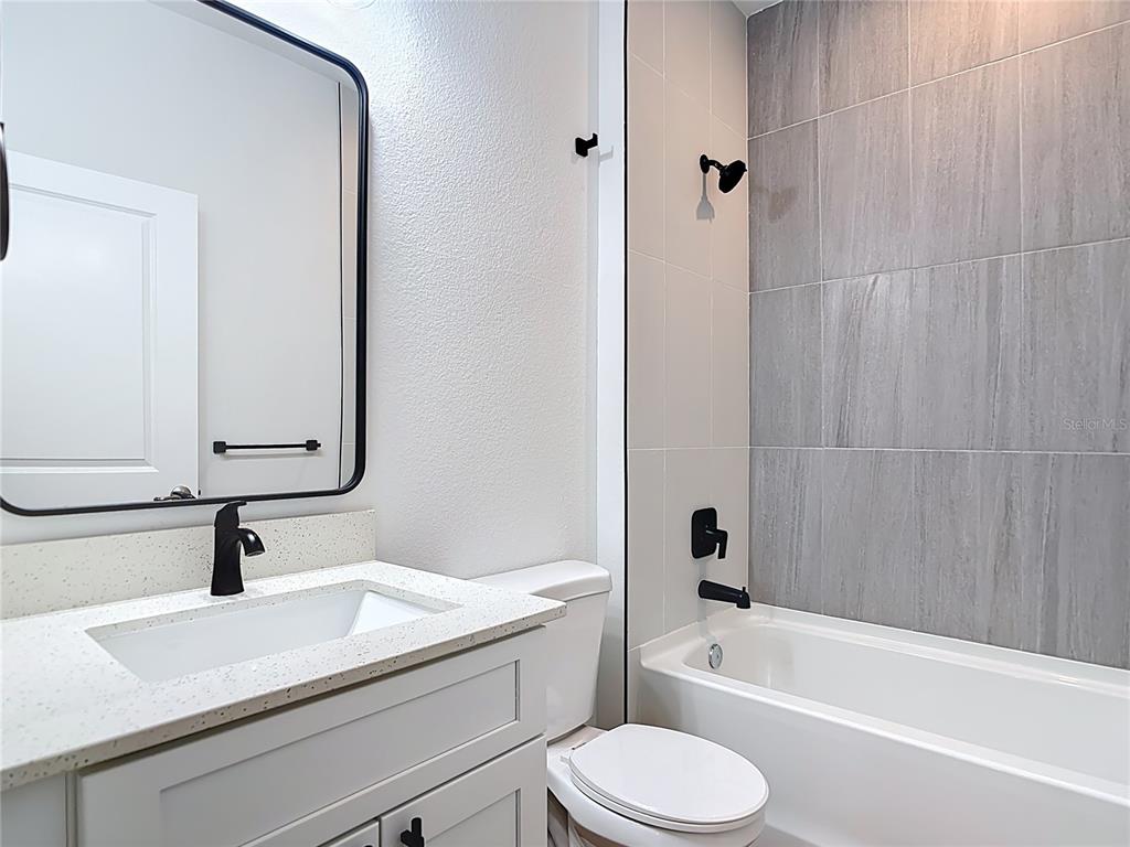 1204 Goshen Road North Port, FL 34288 - Photo 27 of 46 a bathroom with a granite countertop sink toilet and shower