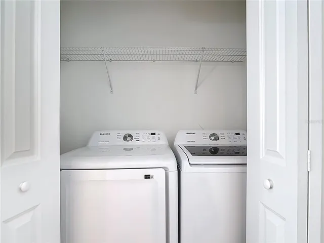 a view of a hallway with washer and dryer