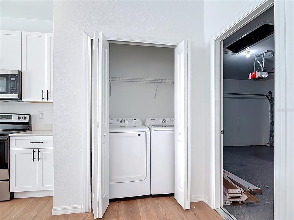 1204 Goshen Road North Port, FL 34288 - Photo 34 of 46 a view of a hallway with washer and dryer