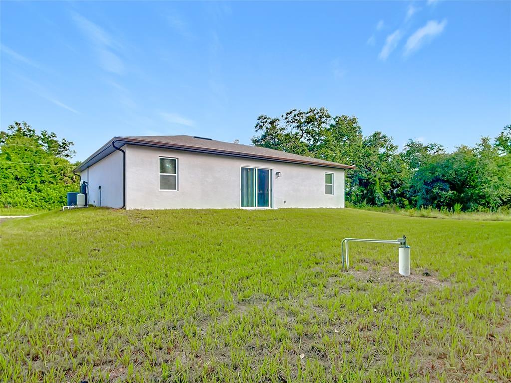 1204 Goshen Road North Port, FL 34288 - Photo 37 of 46 a view of a house with backyard and garden