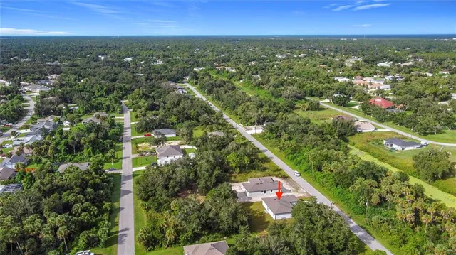 an aerial view of a house with a yard