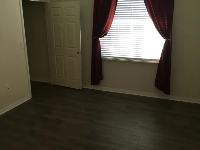 a view of a livingroom with an empty space and a window