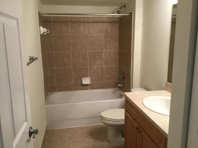 a bathroom with a toilet a sink and bathtub