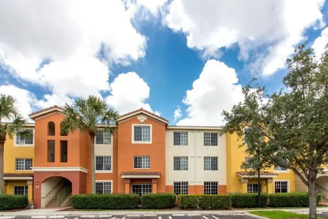 a front view of a residential houses with yard and trees