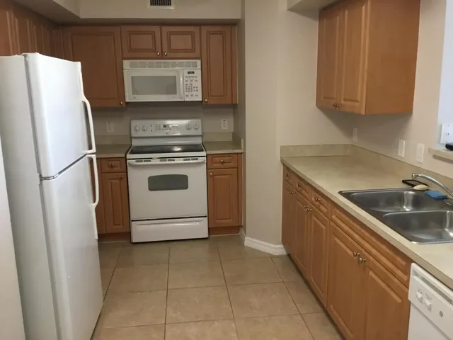 a kitchen with a stove sink and refrigerator