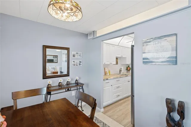 a kitchen with stainless steel appliances granite countertop a sink a stove and cabinets