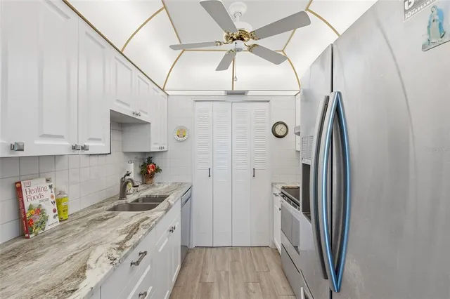 a kitchen with sink a stove and cabinets