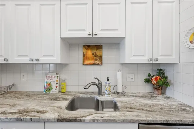 a spacious bedroom with a bed and a chandelier