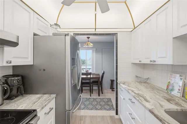 a bedroom with a bed a window and a flat screen tv