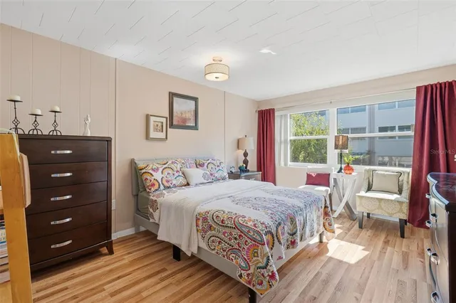 a view of a hallway with wooden floor and closet