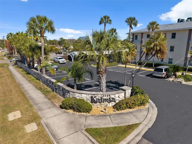 an aerial view of residential building with parking