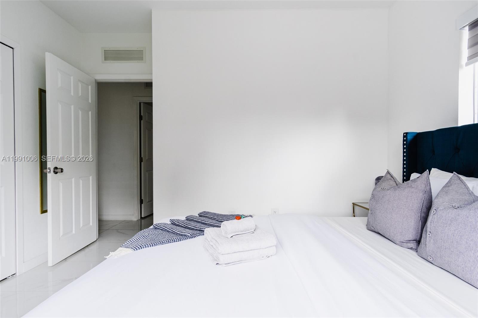 8765 Northwest 22nd Place Miami, FL 33147 - Photo 13 of 37 a bedroom with a bed and a window